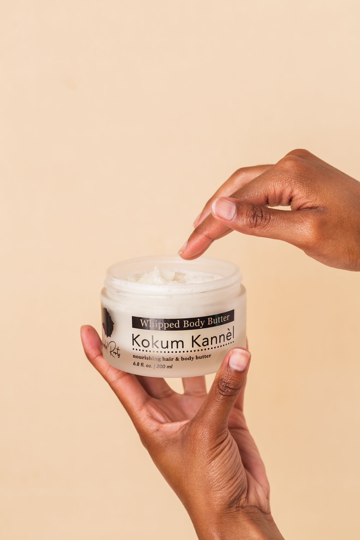 hand holding Kokum Kannèl Whipped Body Butter