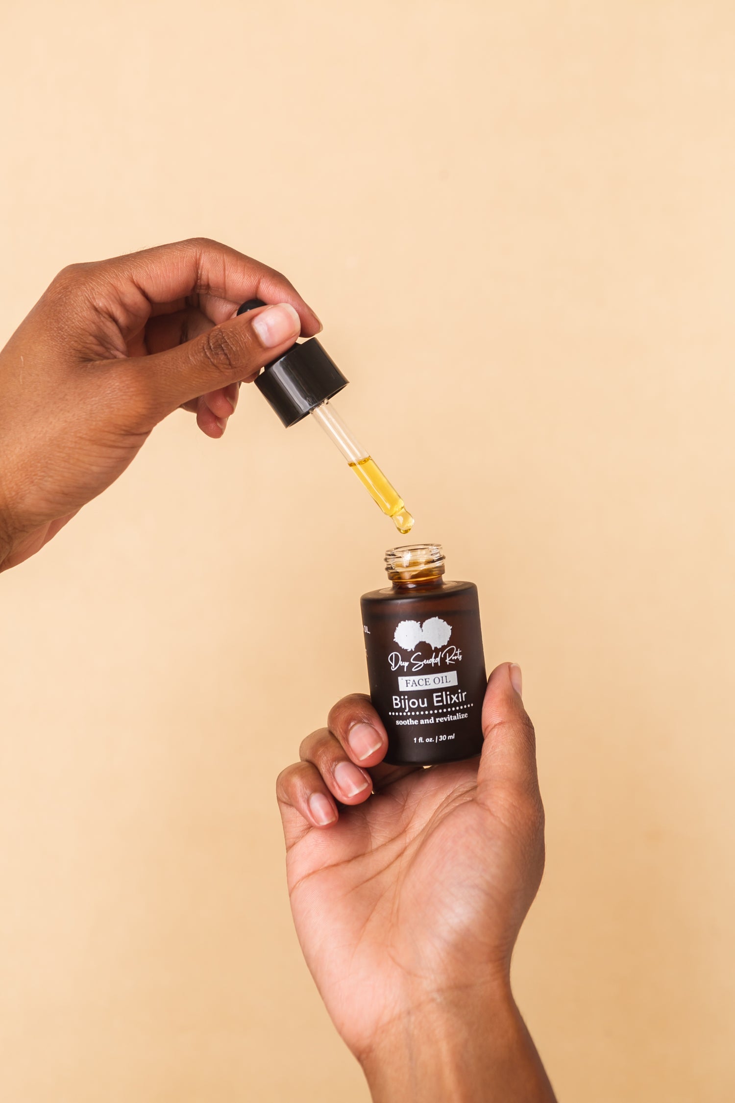 hand holding bijou elixir